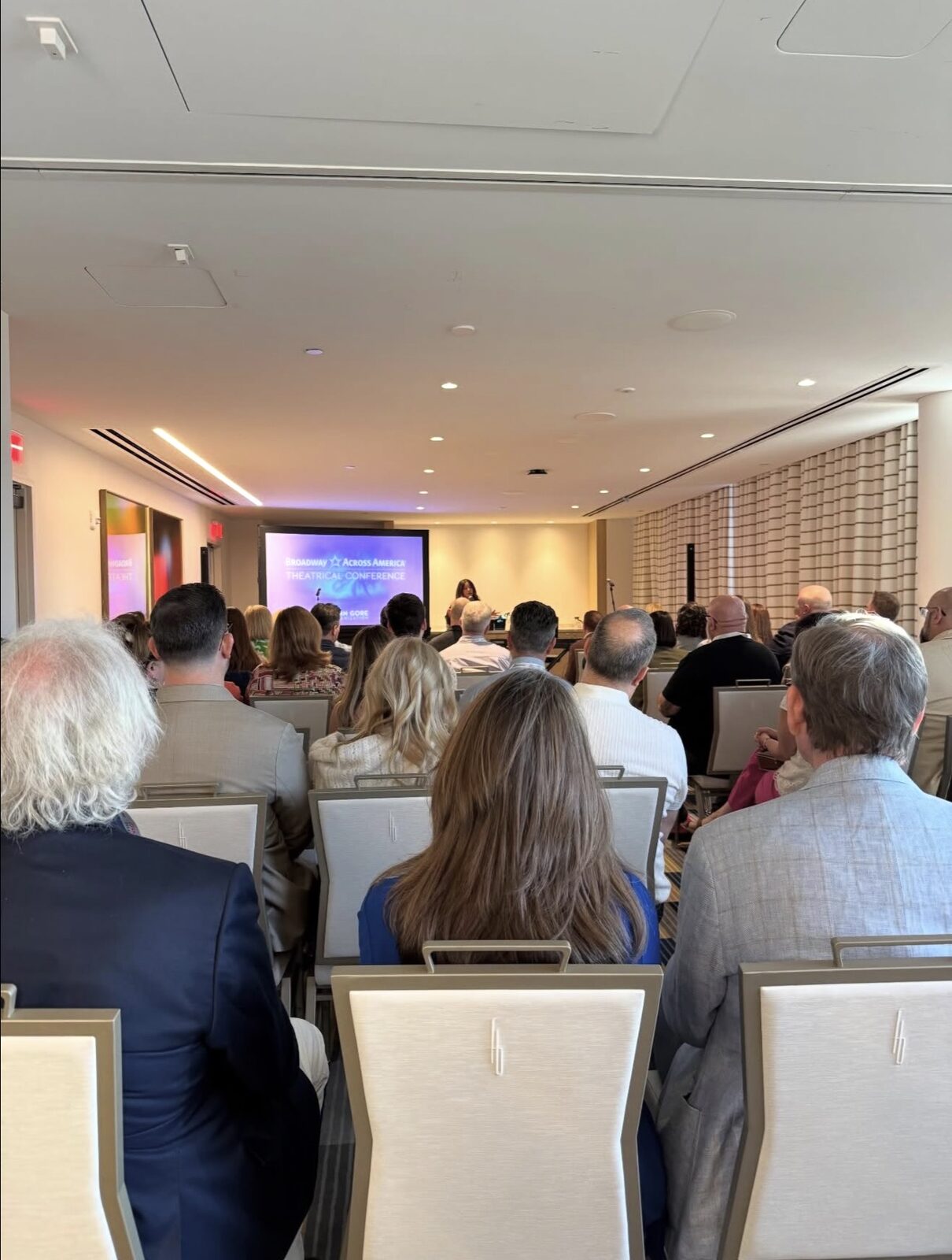 The room in use, full of seated guests