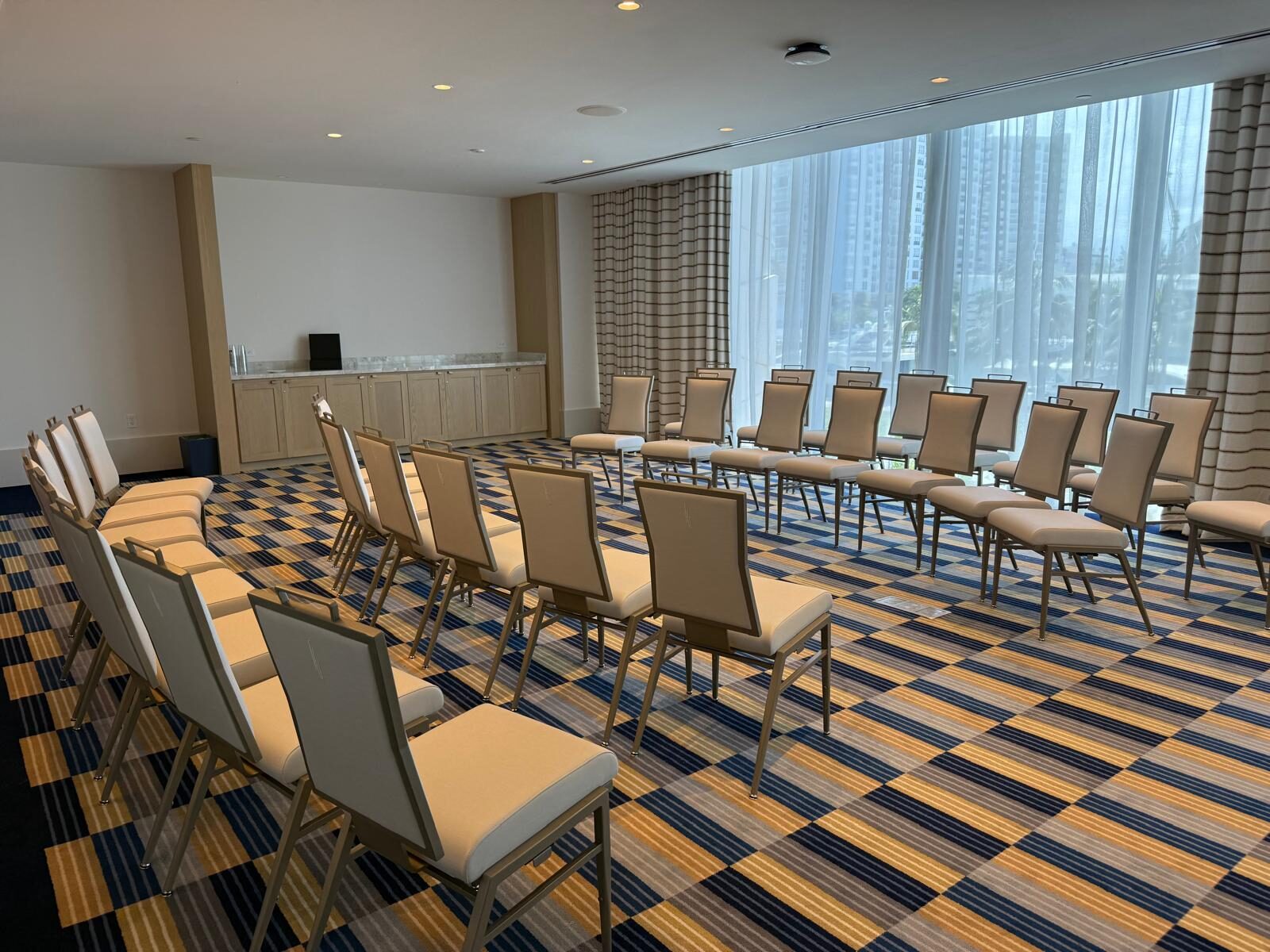 The Shore room set theater-style, facing the windows